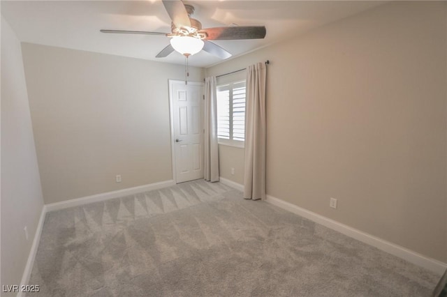 empty room featuring light carpet and ceiling fan