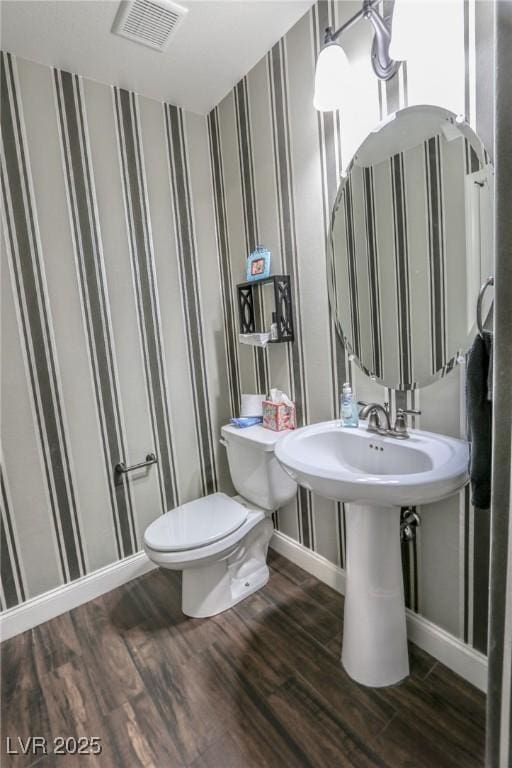 bathroom featuring hardwood / wood-style floors and toilet