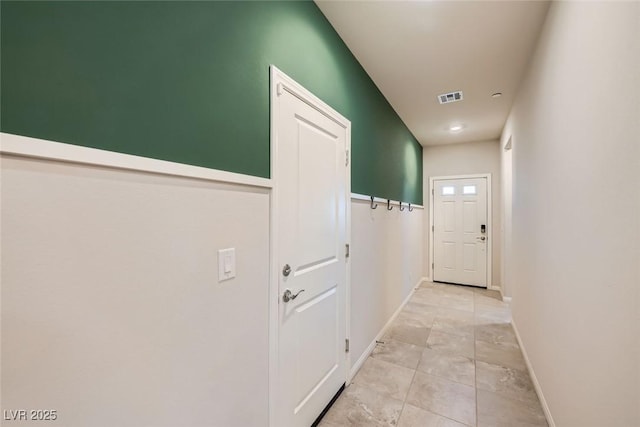 doorway with light tile patterned flooring