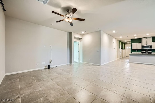 unfurnished room with ceiling fan and light tile patterned flooring