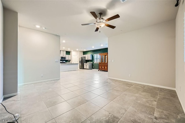 unfurnished living room with ceiling fan and light tile patterned floors