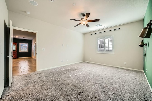 unfurnished room featuring ceiling fan and carpet floors