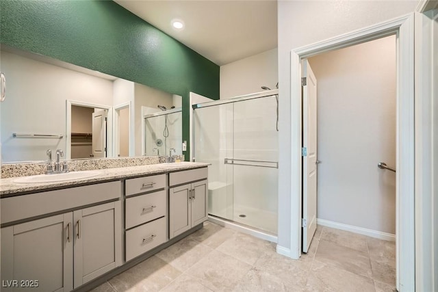 bathroom with an enclosed shower and vanity