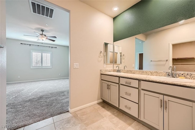 bathroom with ceiling fan, tile patterned flooring, and vanity