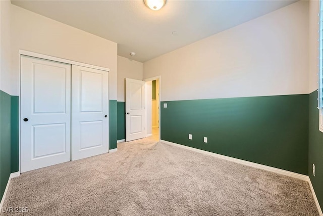 unfurnished bedroom featuring a closet and carpet flooring