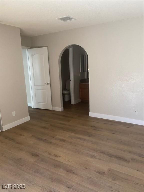 unfurnished room with dark hardwood / wood-style floors