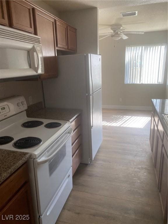 kitchen with ceiling fan, light wood-type flooring, and white appliances