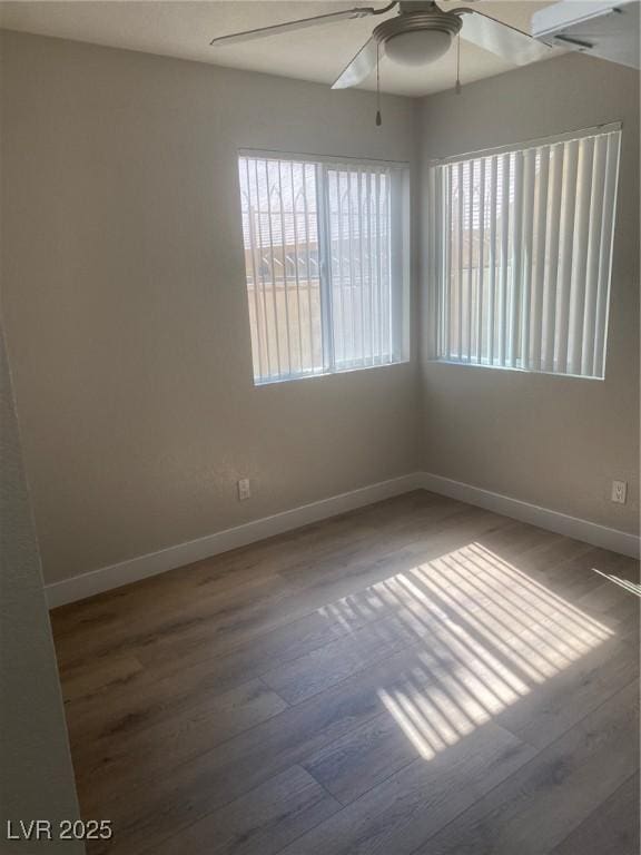 spare room featuring wood-type flooring and ceiling fan