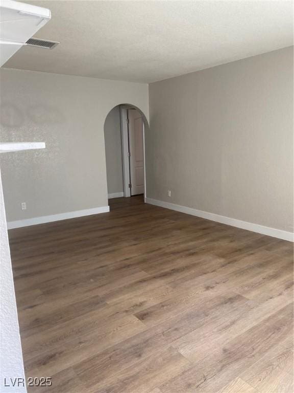 spare room with dark wood-type flooring