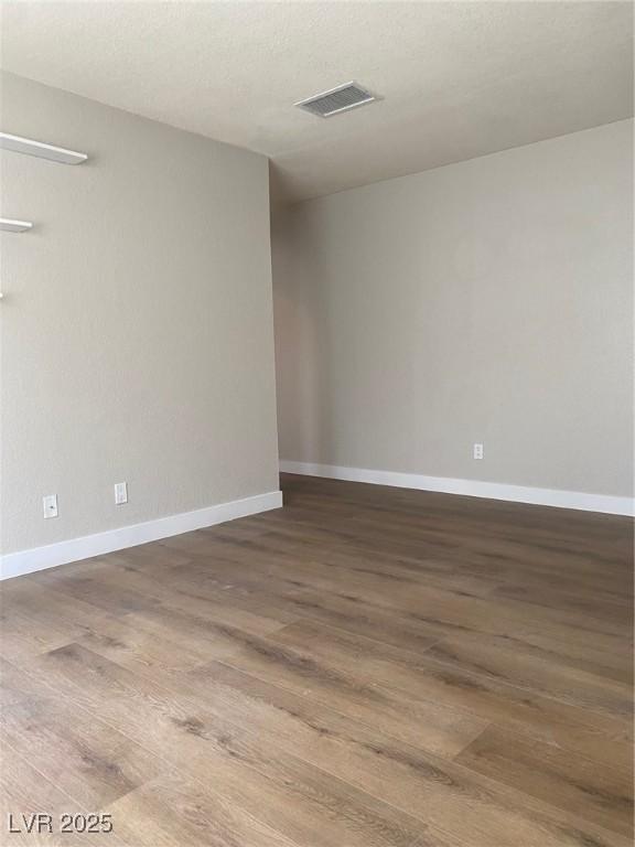 unfurnished room featuring hardwood / wood-style flooring