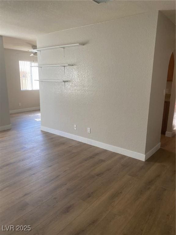 empty room with hardwood / wood-style floors and ceiling fan