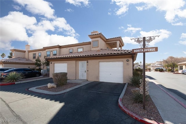 mediterranean / spanish-style home with a garage