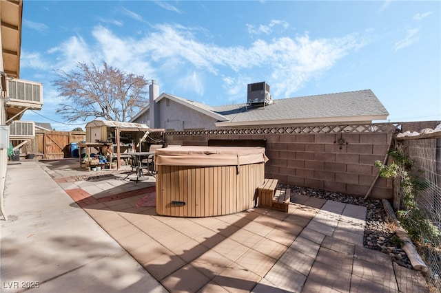 view of patio with a hot tub and cooling unit