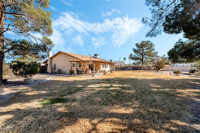 back of property featuring a yard and a patio