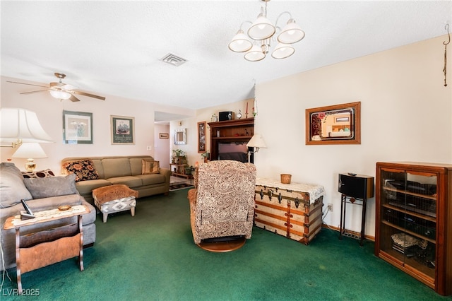 carpeted living room featuring ceiling fan with notable chandelier