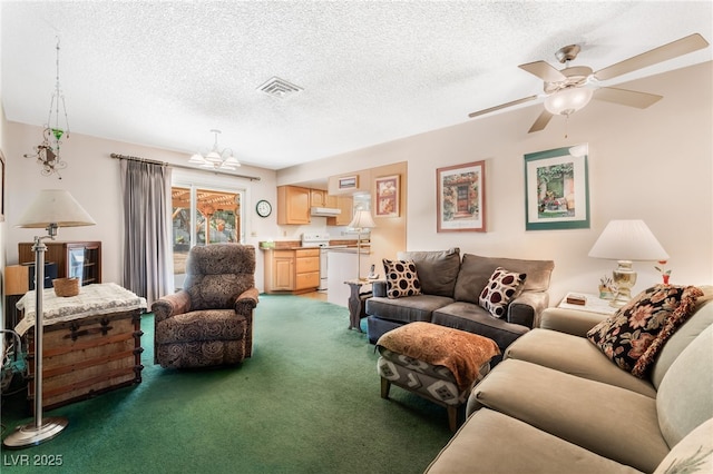 living room with ceiling fan with notable chandelier, a textured ceiling, and dark carpet