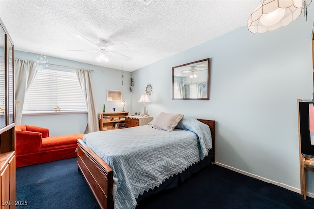 bedroom featuring dark colored carpet, a textured ceiling, and ceiling fan