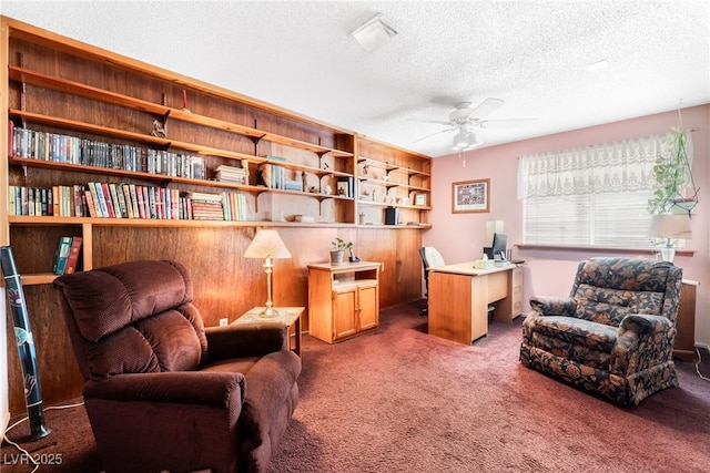 office area with a textured ceiling, carpet floors, and ceiling fan