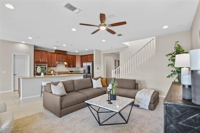 living room featuring ceiling fan and sink