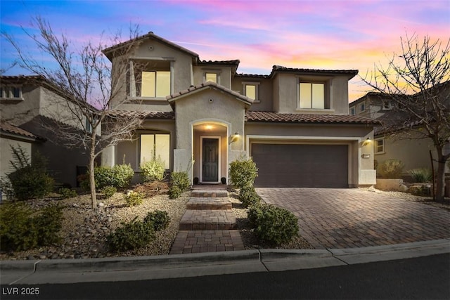 mediterranean / spanish-style house with a garage