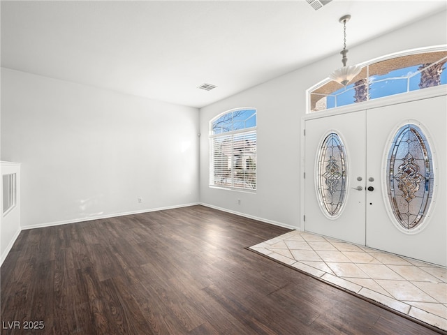 foyer entrance with hardwood / wood-style flooring and french doors