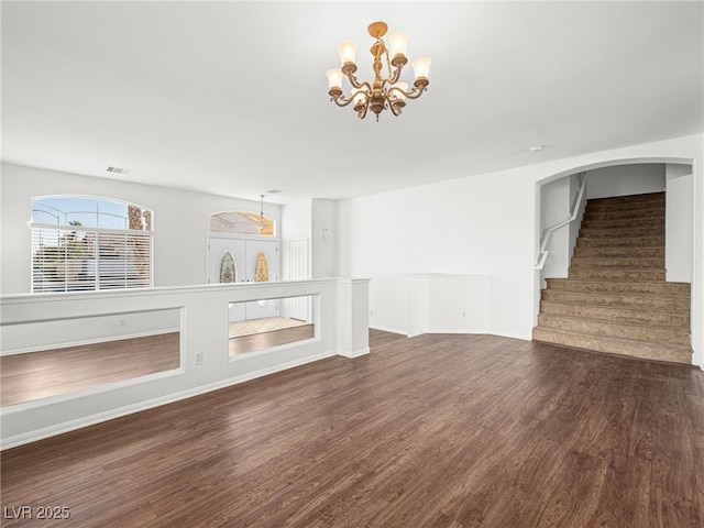 unfurnished living room with french doors, dark hardwood / wood-style flooring, and an inviting chandelier