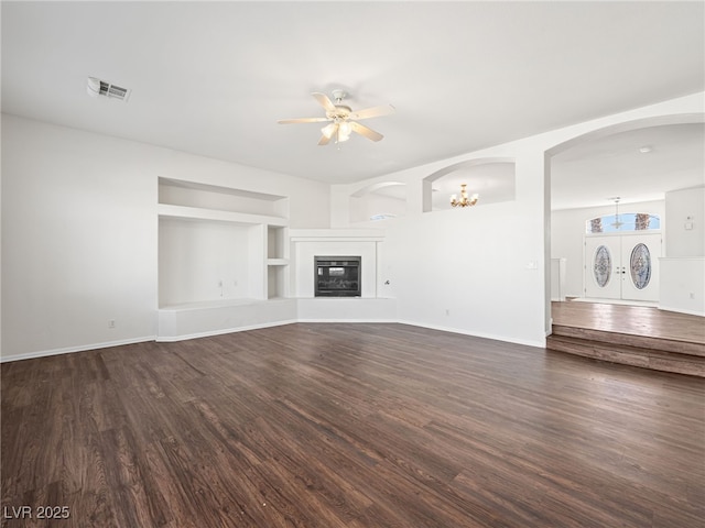 unfurnished living room featuring dark hardwood / wood-style floors, ceiling fan, and french doors