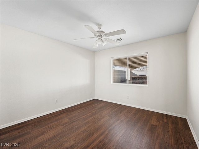 spare room with ceiling fan and dark hardwood / wood-style floors