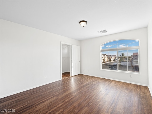 spare room featuring dark hardwood / wood-style flooring