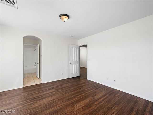 spare room with dark wood-type flooring