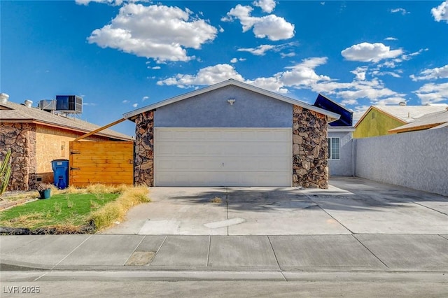 view of front of home with a garage and cooling unit