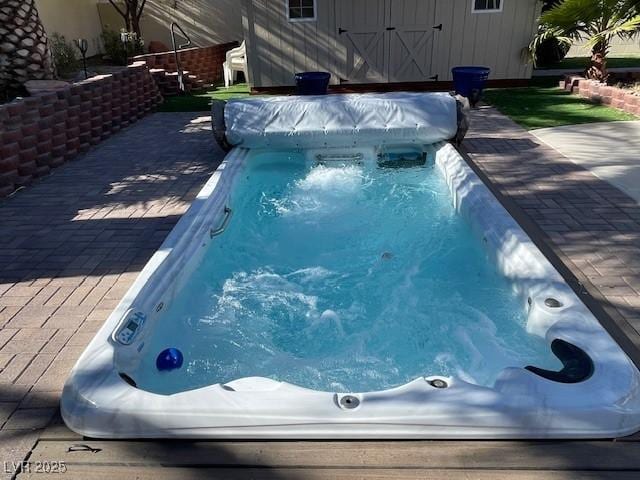 view of swimming pool with a shed