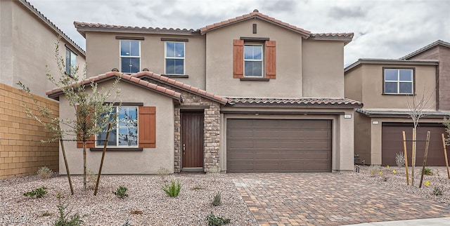 mediterranean / spanish-style house with a garage