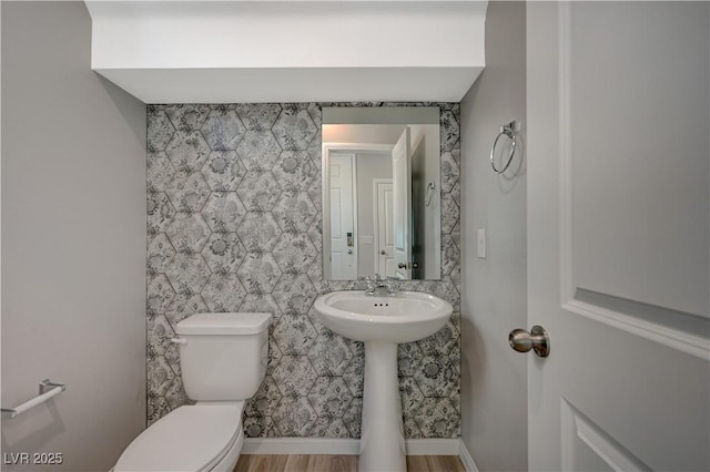 bathroom featuring hardwood / wood-style floors and toilet