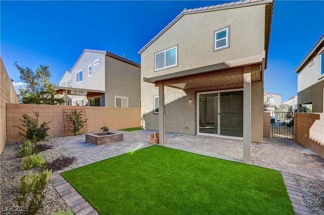 back of house with a yard and a patio