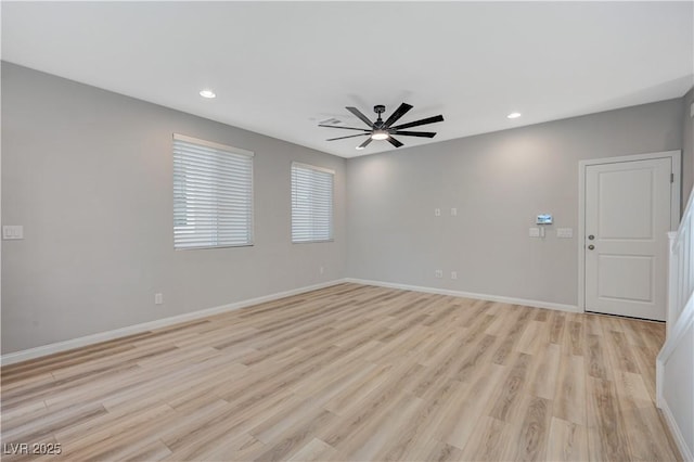 empty room with ceiling fan and light hardwood / wood-style floors