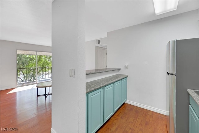 kitchen with stainless steel fridge and light wood-type flooring