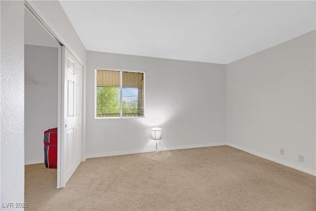 unfurnished room featuring light carpet