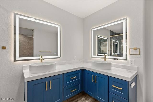 bathroom with vanity and tiled shower