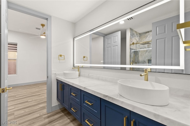 bathroom with ceiling fan, vanity, and wood-type flooring