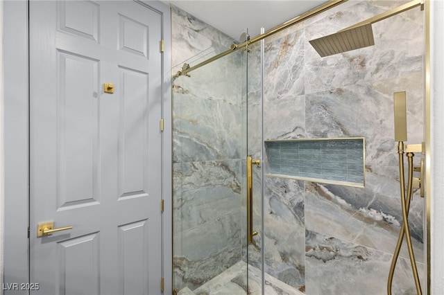 bathroom featuring a shower with shower door