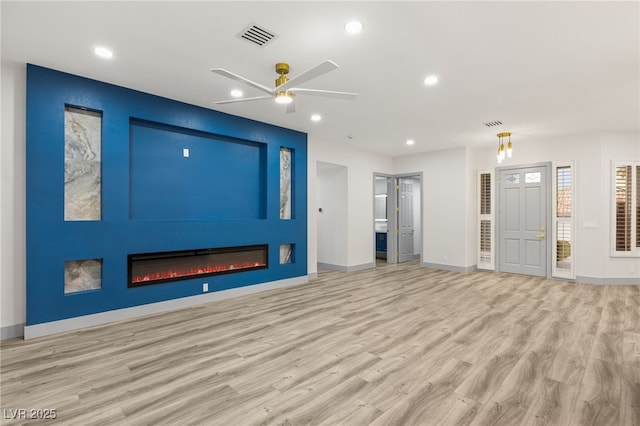 unfurnished living room with ceiling fan and light wood-type flooring