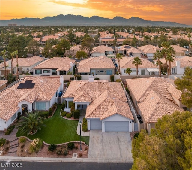 aerial view at dusk featuring a mountain view