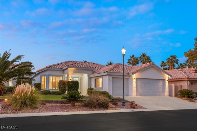 mediterranean / spanish-style house with a garage