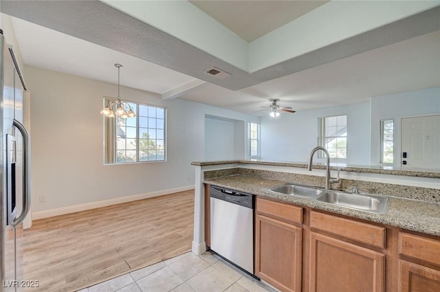 1701 King James St Unit 101, Las Vegas, NV 89144 - kitchen with stainless steel appliances, a sink, plenty of natural light, and baseboards