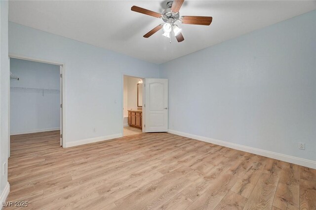 1701 King James St Unit 101, Las Vegas, NV 89144 - unfurnished bedroom with light wood finished floors, baseboards, a spacious closet, and a closet