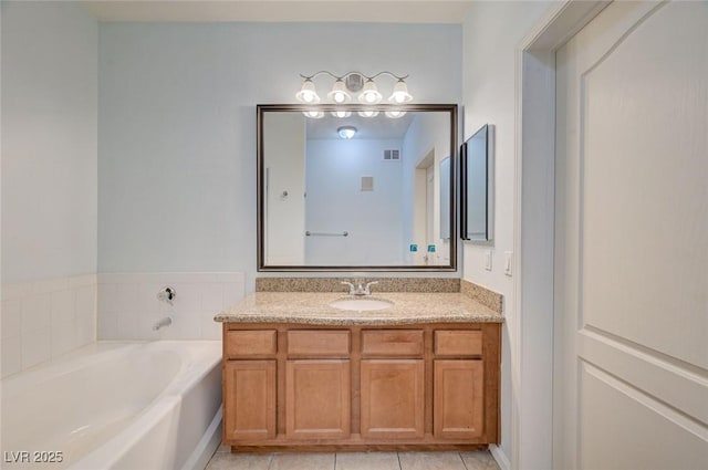 1701 King James St Unit 101, Las Vegas, NV 89144 - bathroom featuring vanity, a garden tub, and tile patterned flooring