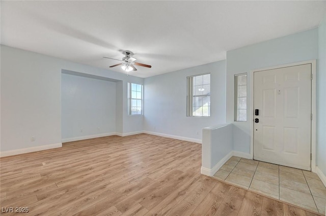1701 King James St Unit 101, Las Vegas, NV 89144 - foyer entrance with light wood finished floors, a ceiling fan, and baseboards