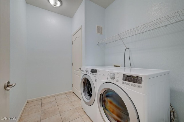 1701 King James St Unit 101, Las Vegas, NV 89144 - laundry room with independent washer and dryer, baseboards, and light tile patterned floors