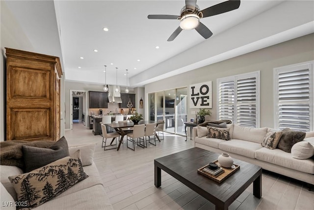 living room featuring ceiling fan and light wood-type flooring